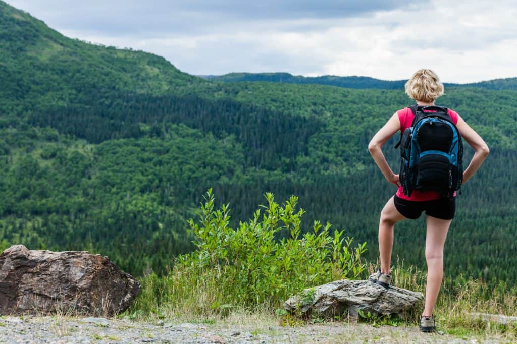 Young Woman Looking at the View From the Top of the Hill